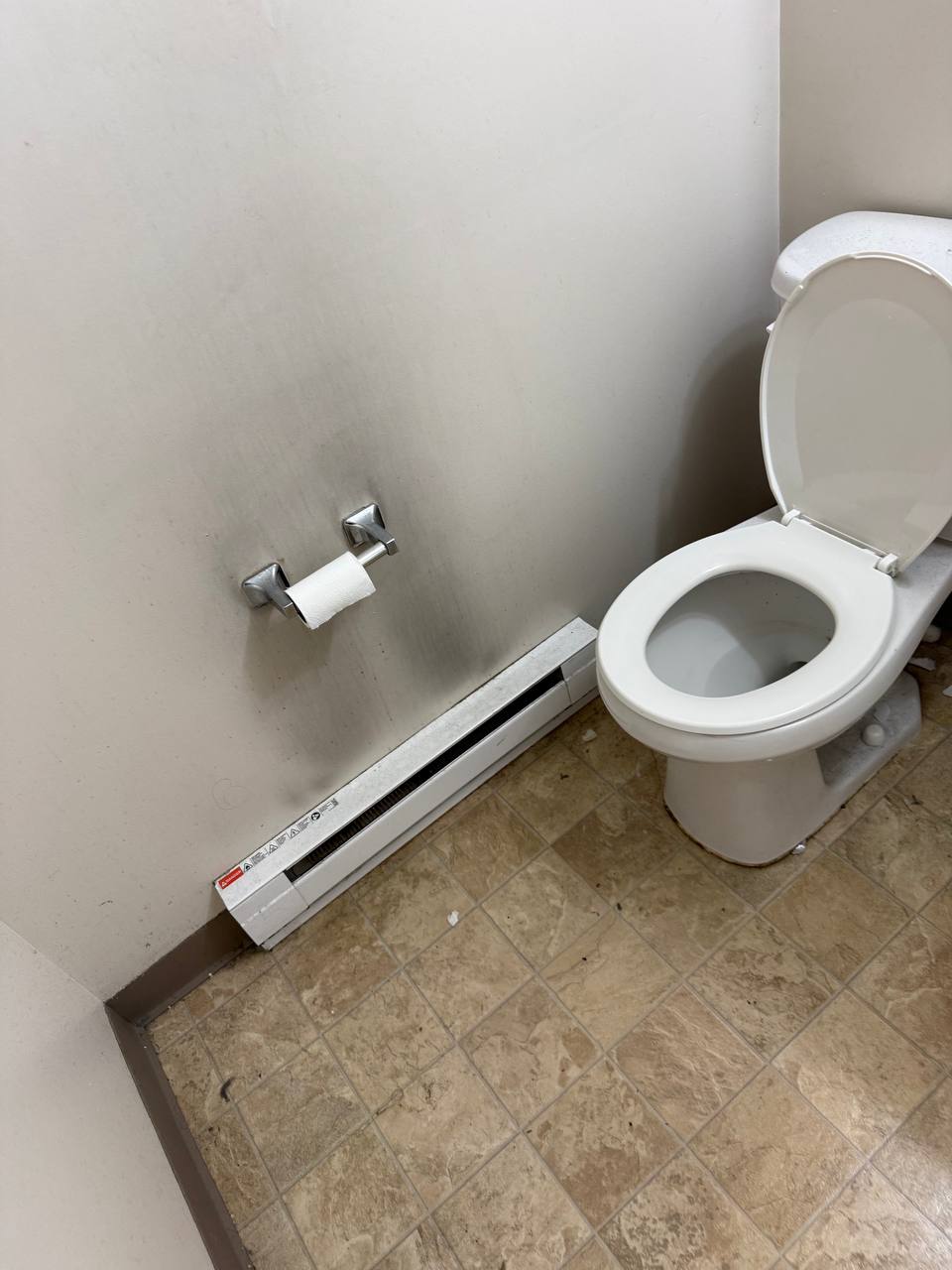 Bathroom wall, toilet and floor before cleaning